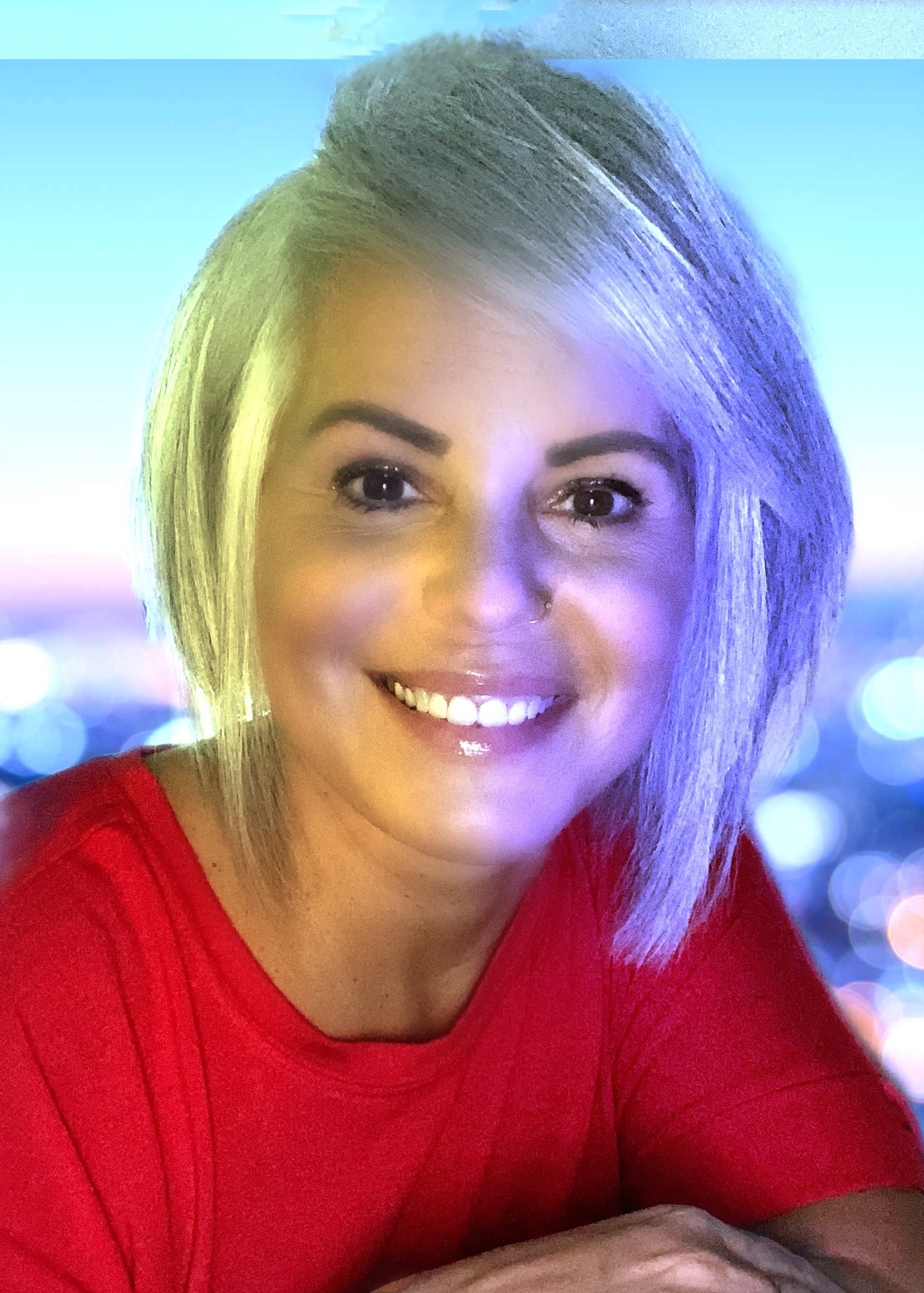 A woman with white hair smiling for the camera.